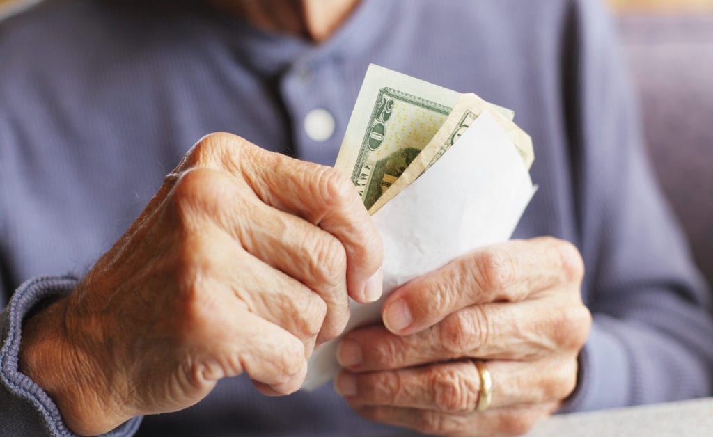 senior man holding money