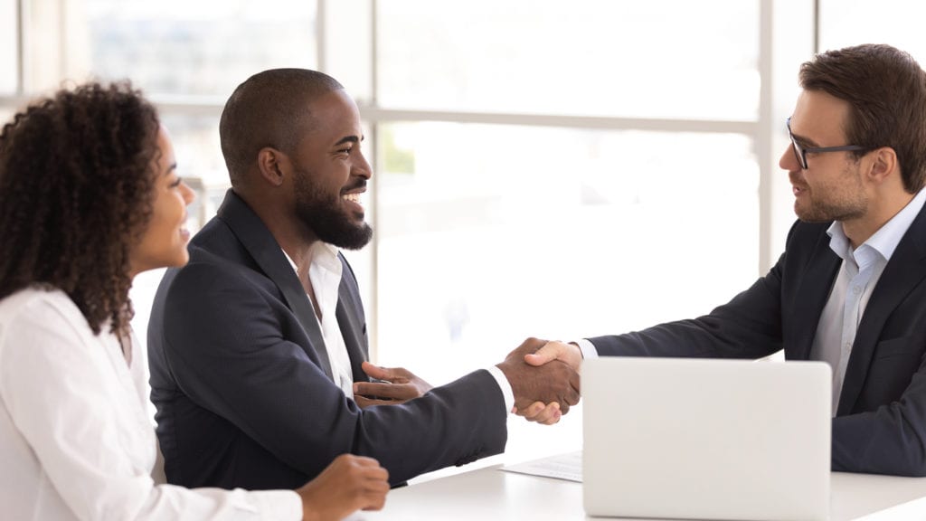 couple shaking hands with lender
